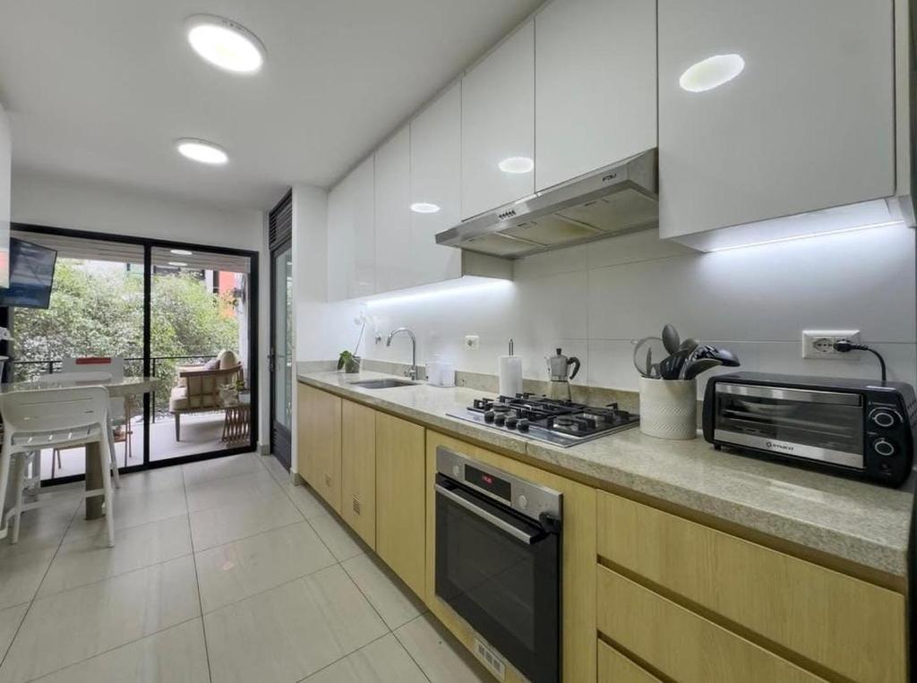 a kitchen with a sink and a stove top oven at David House 3BR Pent Mira in Lima