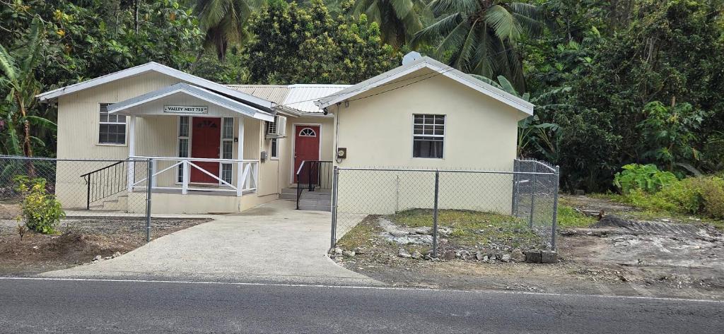 a small white house with a red door at Valley Nest 758 in Castries