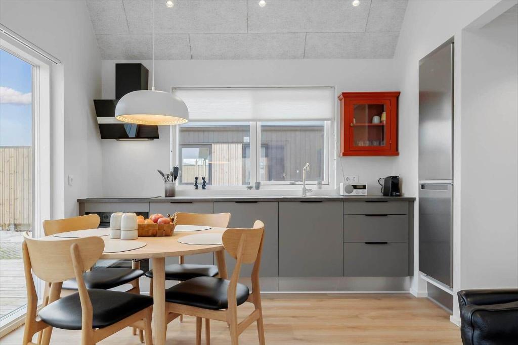 a kitchen and dining room with a table and chairs at 9954-Hvide-Sande-Langsand-214 in Hvide Sande
