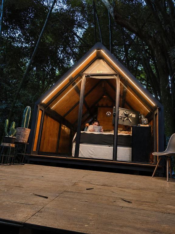 a small tent with a bed inside of it at Cabana recanto da TOCA in Ilhabela