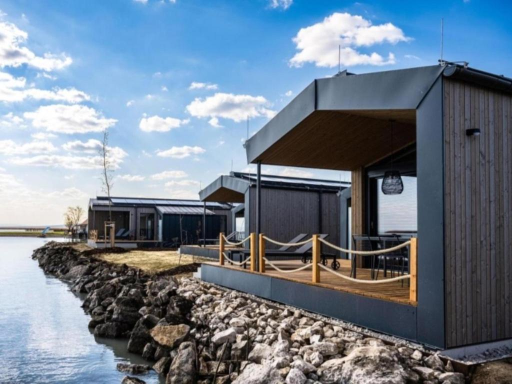 a building next to a body of water at Guesthouse Seeblick in Breitenbrunn