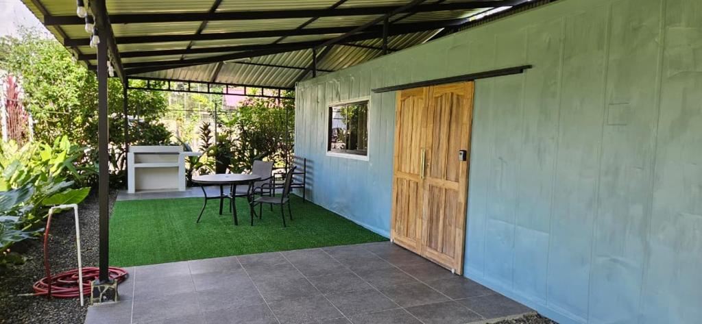 a patio with a table and chairs and a wooden door at Elegant studio in Fortuna