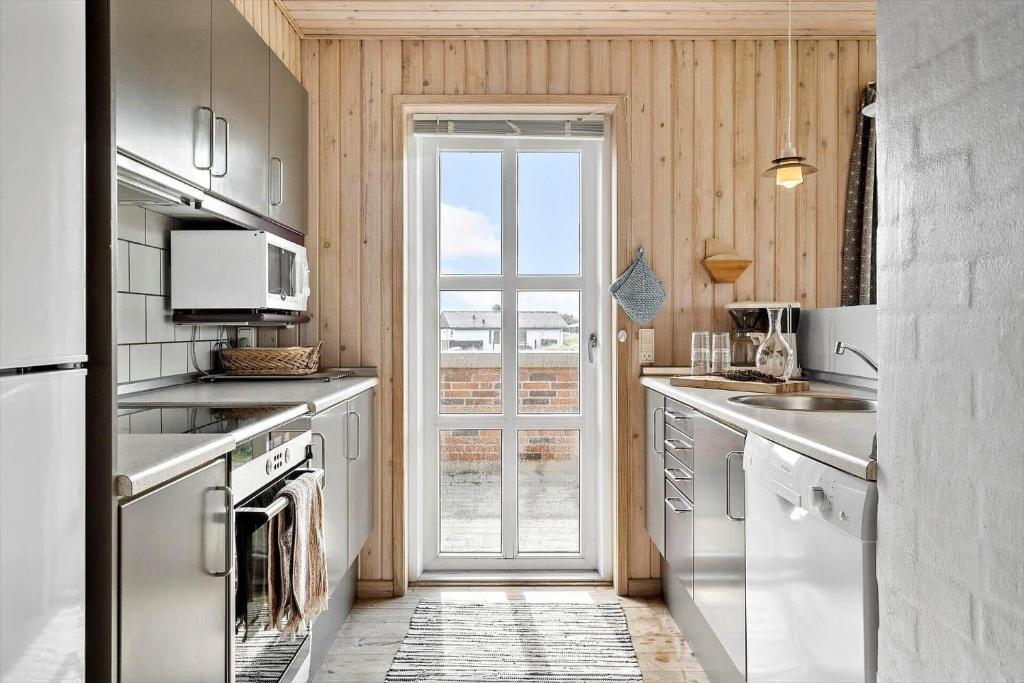 a kitchen with stainless steel appliances and a window at 380-Harboore-Bethaniavej-9 in Harboør