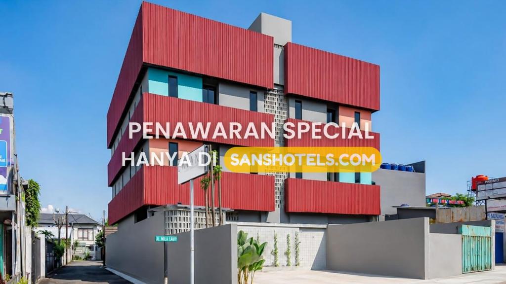 a building with a sign on the side of it at Sans Stay Bintaro in Pondoklang