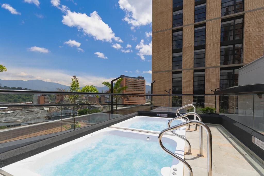 a swimming pool on the roof of a building at Metropolitan Living by HOUSY in Medellín