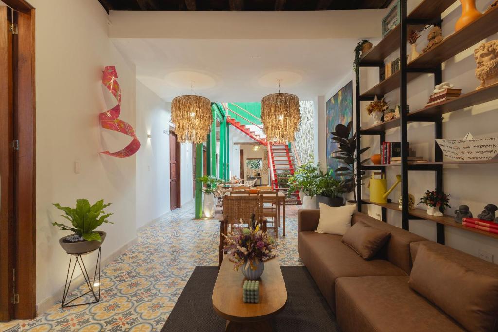 a living room with a couch and a table at Casa Aura Hotel in Bogotá