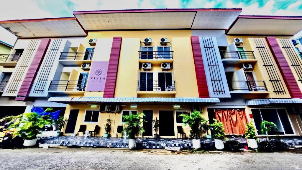 a building with colorful windows and balconies on it at Vista Residence Patong in Patong Beach