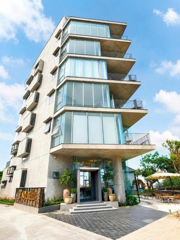 a tall building with a glass facade at Solia Hill Hotel in Dong Hoi