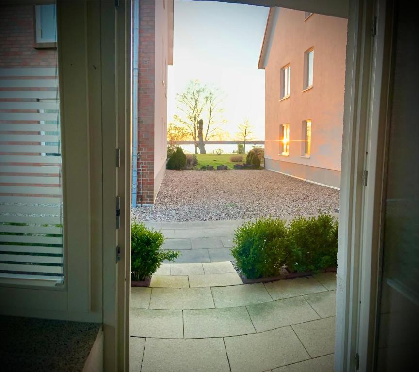 an open door of a house with a courtyard at Susi's Seeblick in Waren