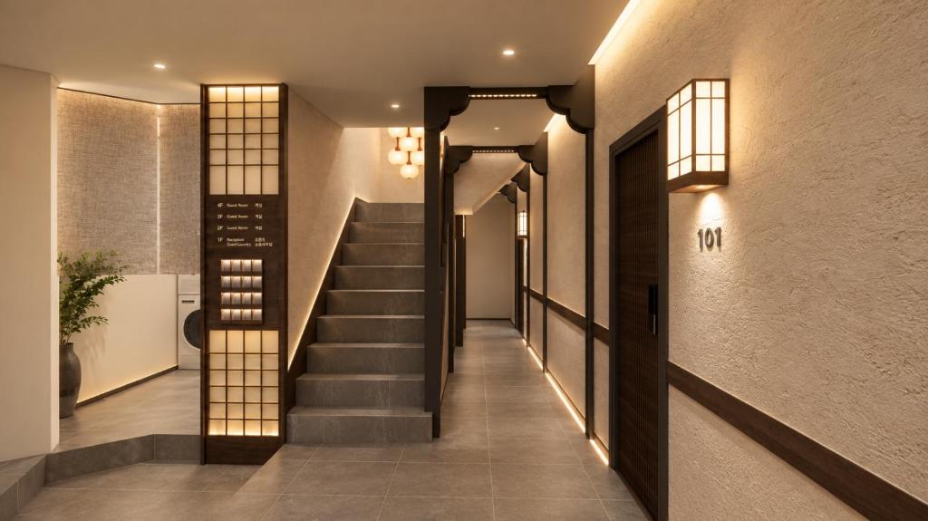 a hallway with stairs in a house with lights at Stay Damyeon in Seoul