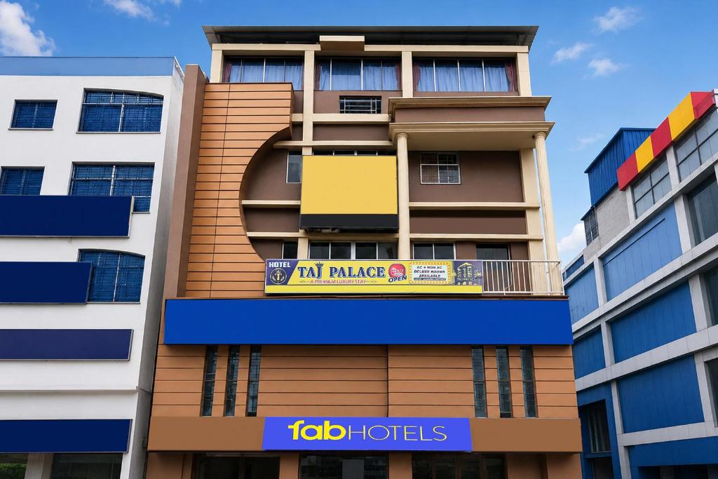 an apartment building with a yellow sign on it at FabHotel Taj Palace in kolkata