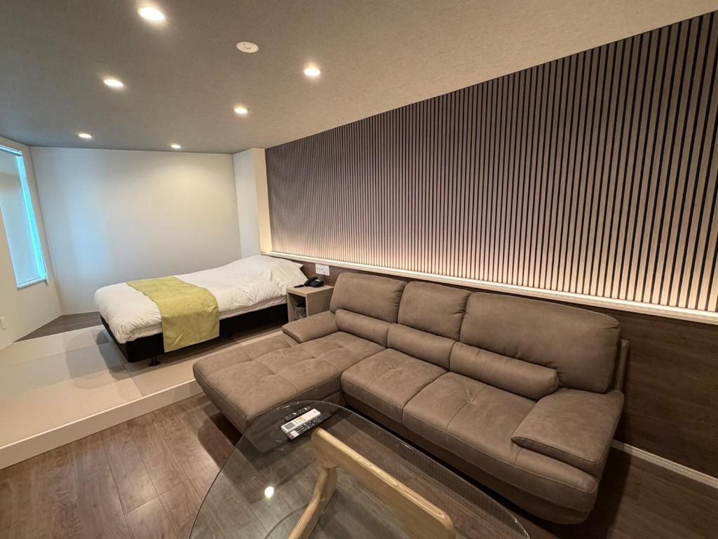 a living room with a couch and a bed at Hotel Shindbad Aomori -Love Hotel- in Aomori