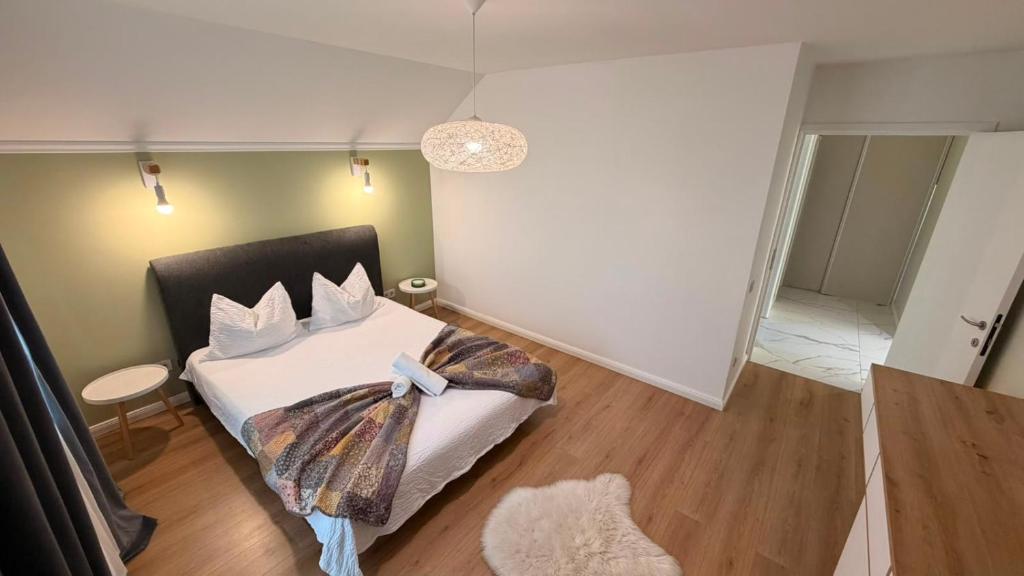 a bedroom with a bed with a bow on it at Matei Rent Apartments - Premium Stays & Free Parking in Baia Mare