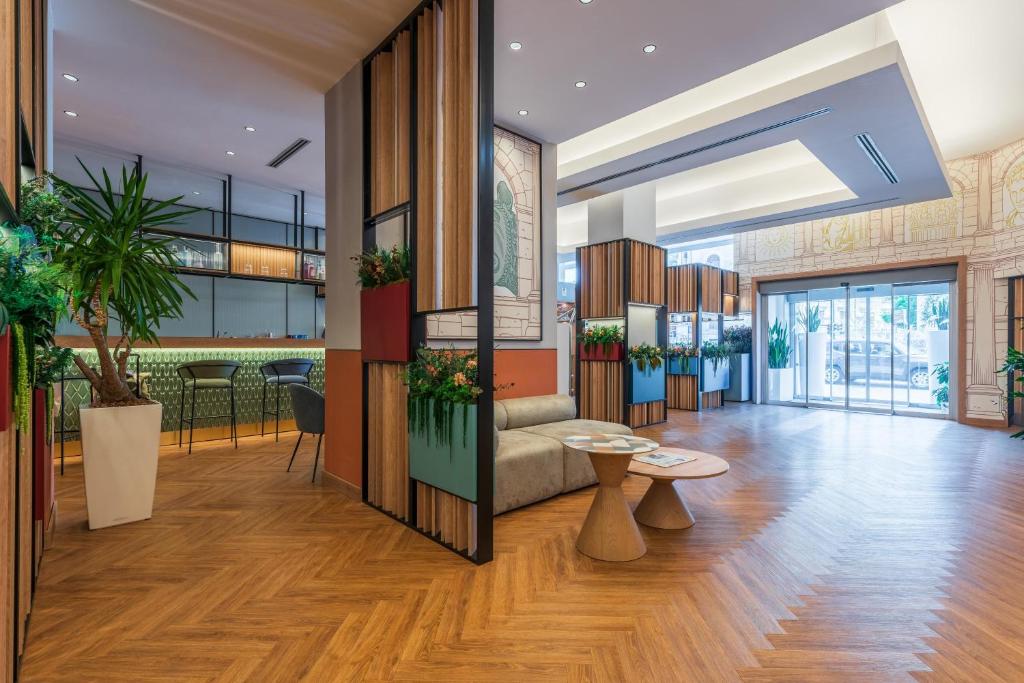 a lobby with a couch and a table at Hilton Garden Inn Rome Colosseum in Rome