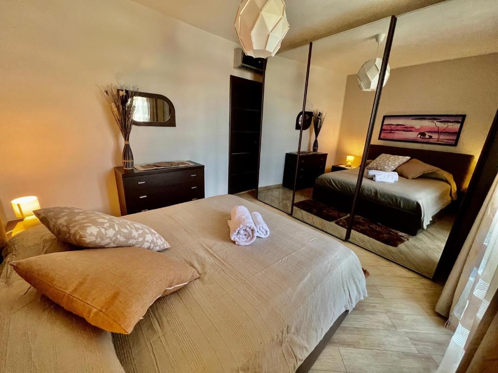 a bedroom with a bed with a large mirror at Regina House Vigevano in Vigevano