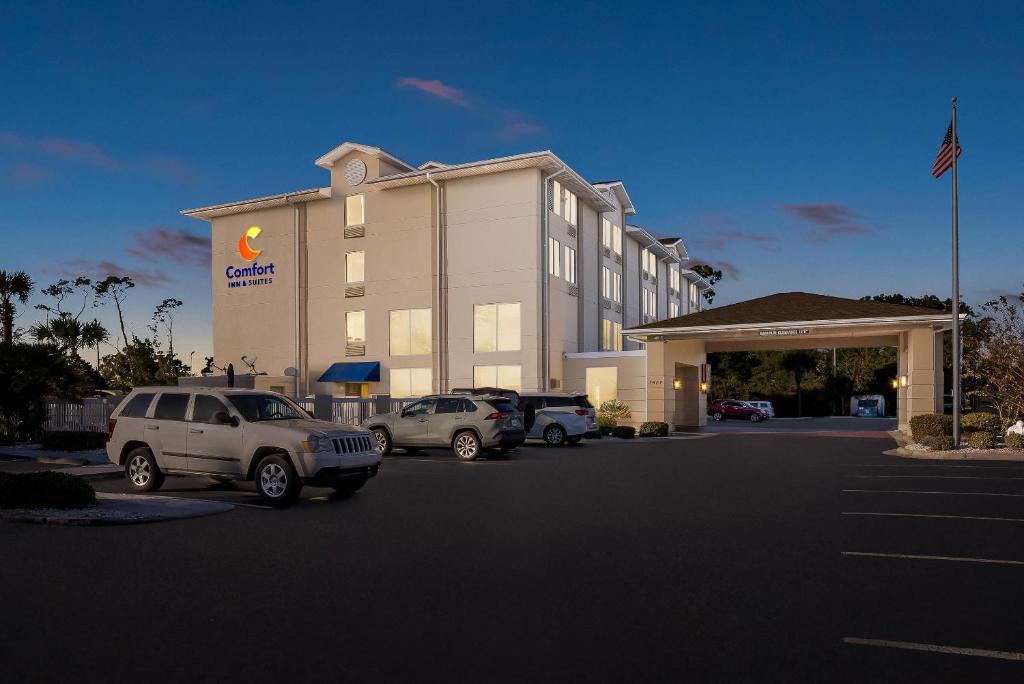 a hotel with cars parked in a parking lot at Comfort Inn & Suites Panama City - St Andrew in Panama City