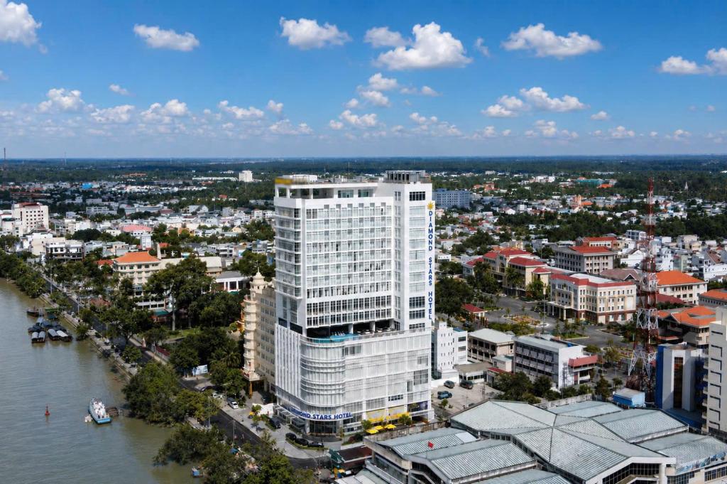 an aerial view of a city with a tall building at Diamond Stars Ben Tre Hotel in Ben Tre