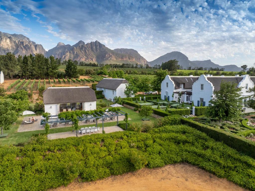 an aerial view of a house with mountains in the background at Brookdale Estate - Manor House in Paarl
