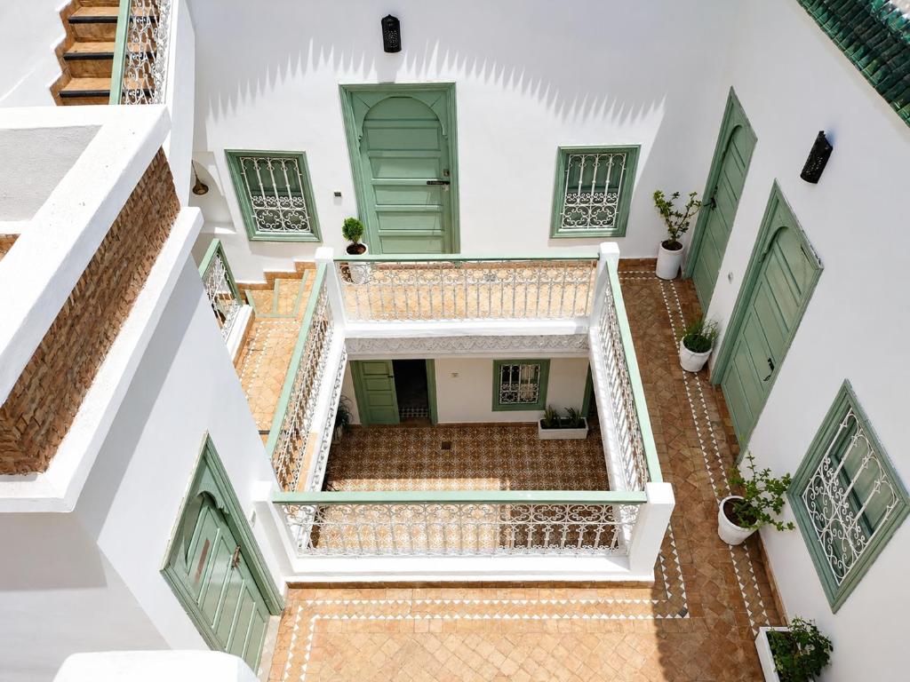 an overhead view of a building with stairs and a green door at Dar la famille Marrakech in Marrakesh