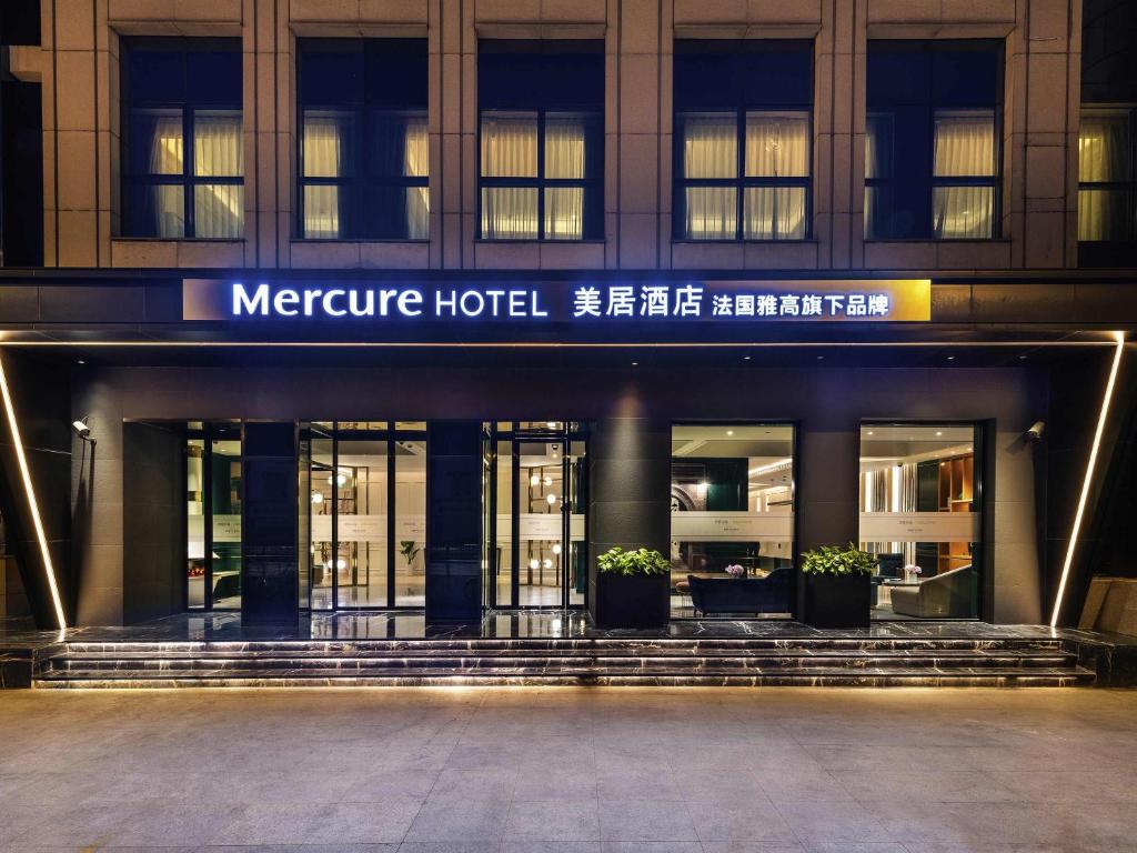 a facade of a hotel at night at Mercure Shanghai Yu Garden On the Bund - 5 mins taxi to Nanjing Road and Bund in Shanghai