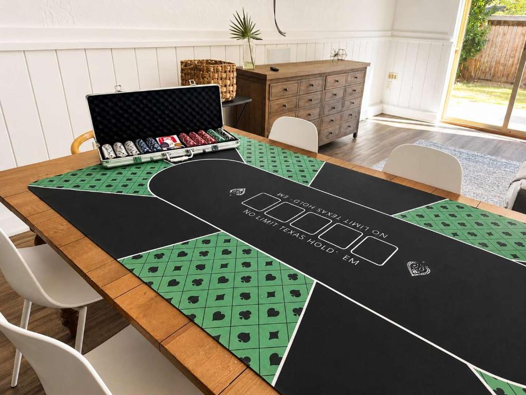 a table with a laptop sitting on top of it at The Hangout House With Bonus Game Room & Foosball in Coeur d'Alene