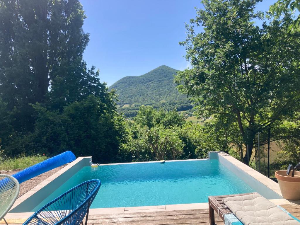 a swimming pool with a view of a mountain at Home in Drome provençale in Vesc
