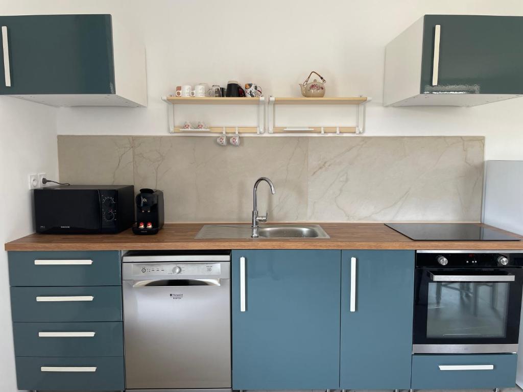 a kitchen with a sink and a dishwasher at Préchacq-les-Bains in Préchacq