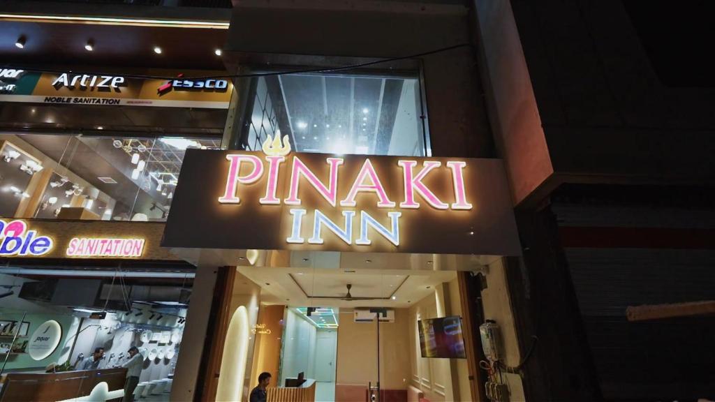 a sign for a parakeet inn on the side of a building at Hotel Pinaki Inn in Ujjain