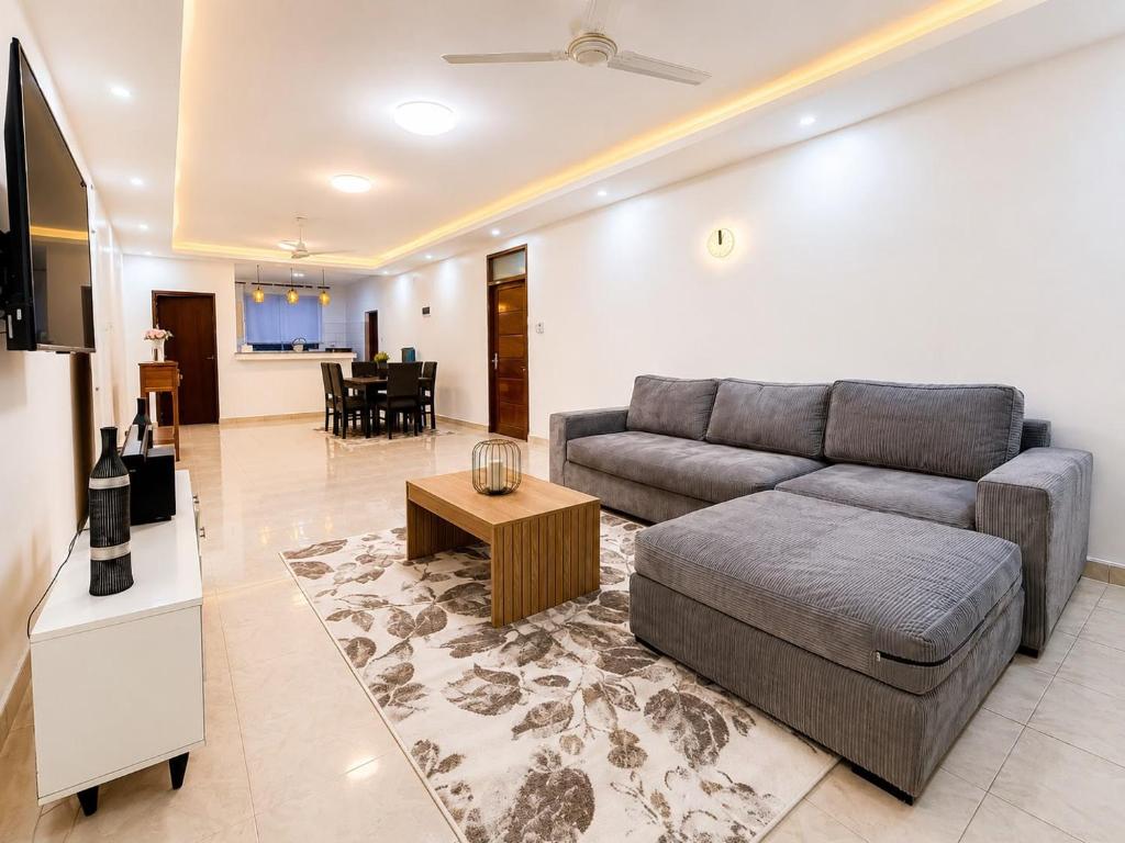 a living room with a couch and a table at Nyali 3 Bedroom Apartment Skyview in Mombasa