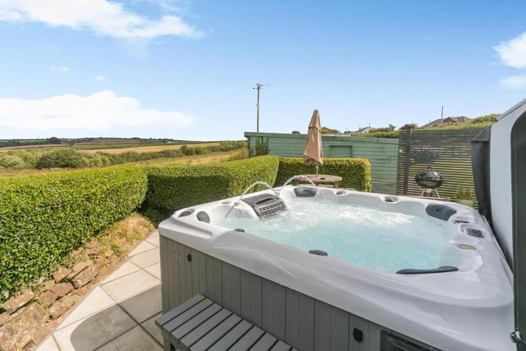 a jacuzzi tub sitting on a patio at 2 Bed in Bideford oc-housm in Clovelly