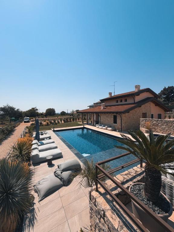 a swimming pool with lounge chairs next to a building at Residenza Monticelli in Lavagno