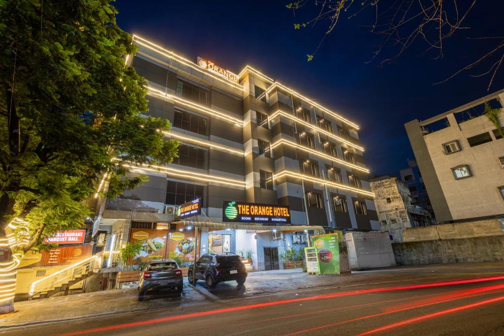 a hotel building with cars parked in front of it at The Orange Hotel in Visakhapatnam