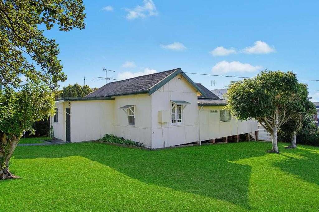 a white house with a green yard at Almare, 7 Gowing Street in Crescent Head