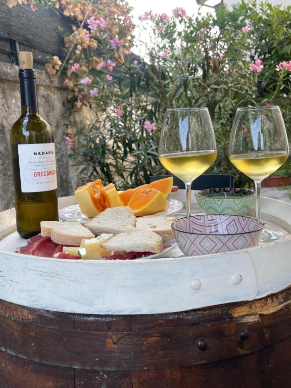 a plate of food and two glasses of wine at BLUE SEA Villa Versilia- Lido Di Camaiore in Lido di Camaiore