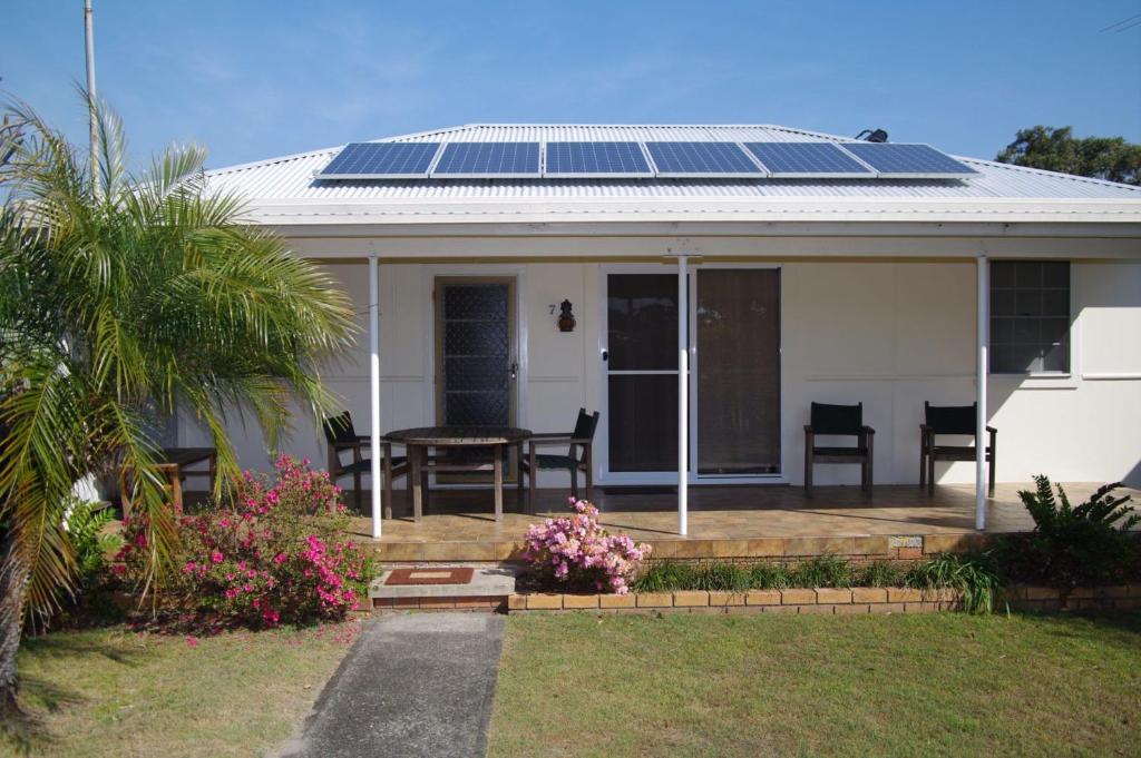 a house with solar panels on the roof at Fleur Cottage, 7 Willow Street in Crescent Head
