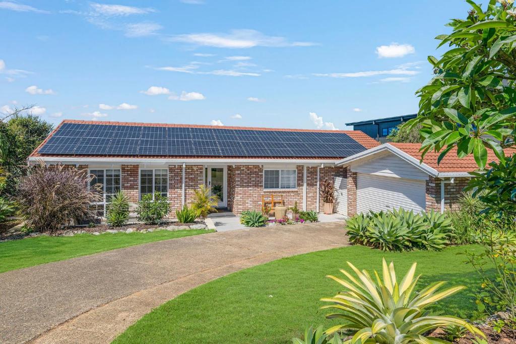 a house with solar panels on the roof at Lighthouse Beach Luxury in Port Macquarie