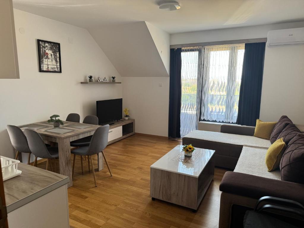 a living room with a couch and a table at APARTMaN HAPPY PLACE in Soko Banja