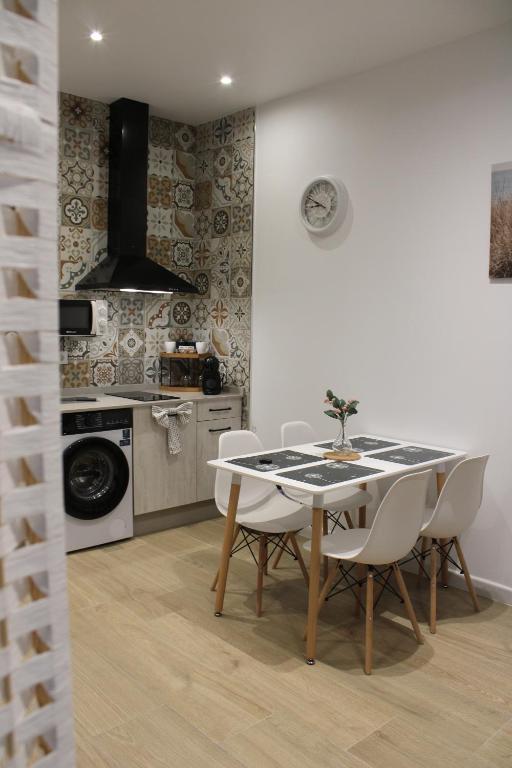 a dining room with a table and chairs in a kitchen at Los Llanos Loft & Suites in Manzanilla