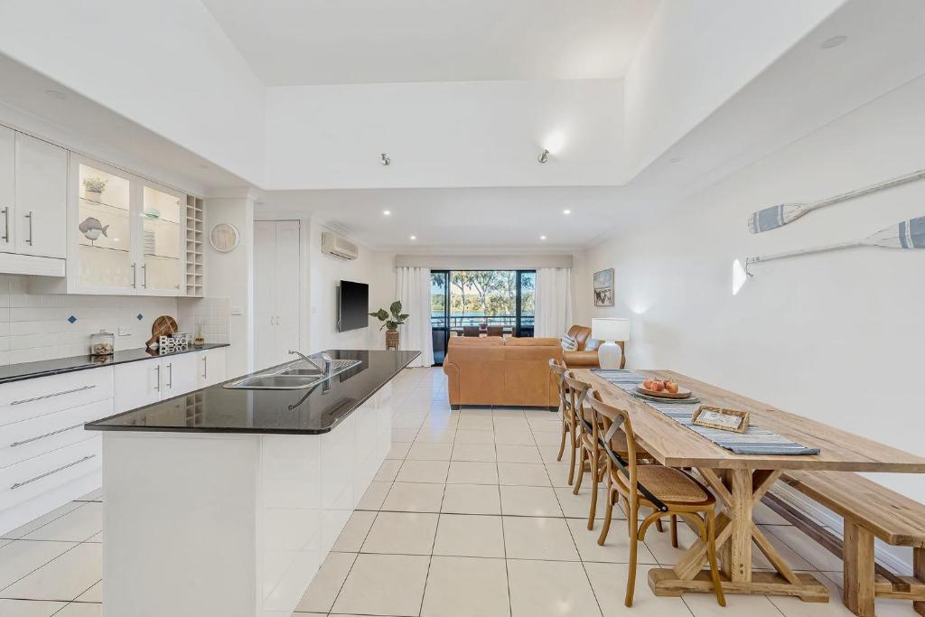 a kitchen and living room with a table and chairs at Pippies, your water view escape in North Haven