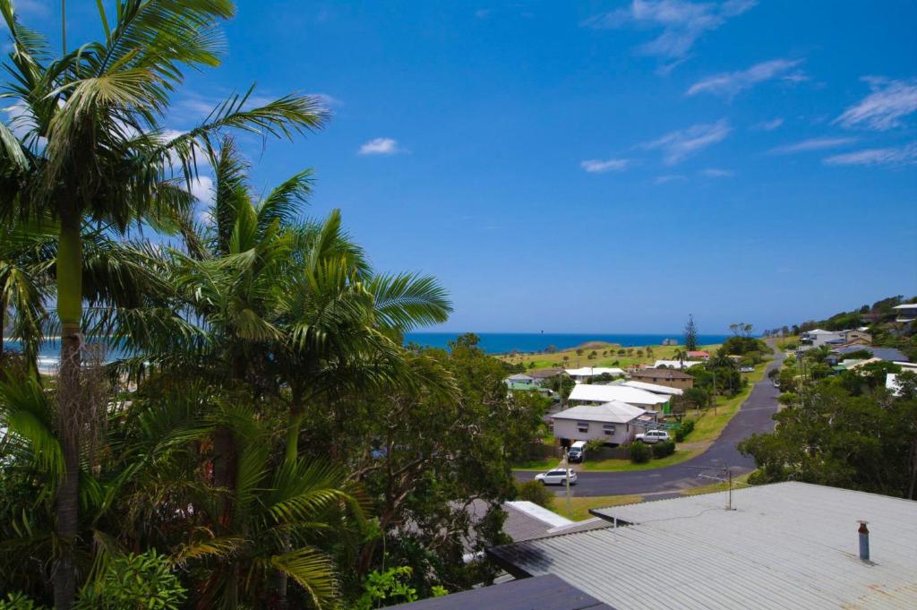 a view from the balcony of a house with palm trees at Rosemaree, 24 East Street in Crescent Head