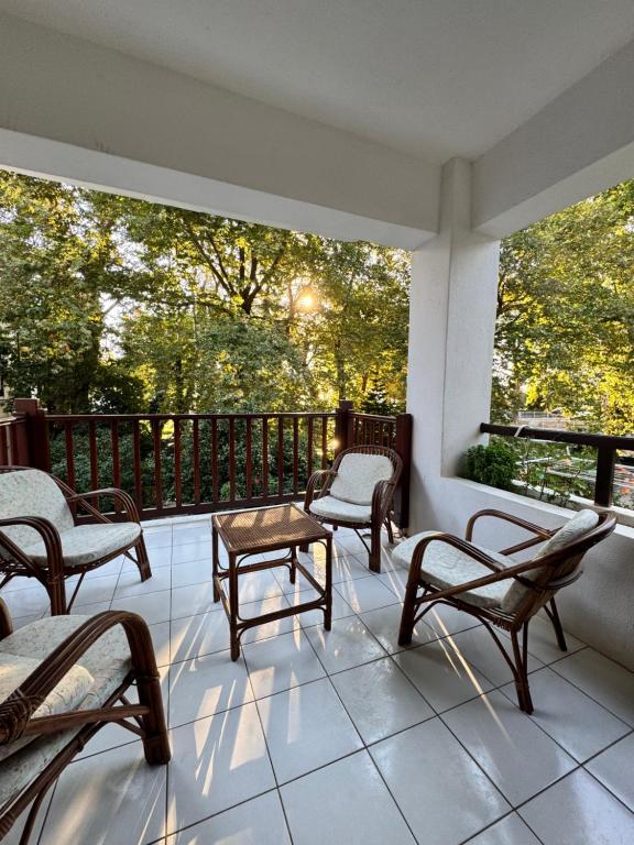 a porch with chairs and a table on a balcony at Serene appartment at St. Ioannis in Agios Ioannis Pelio