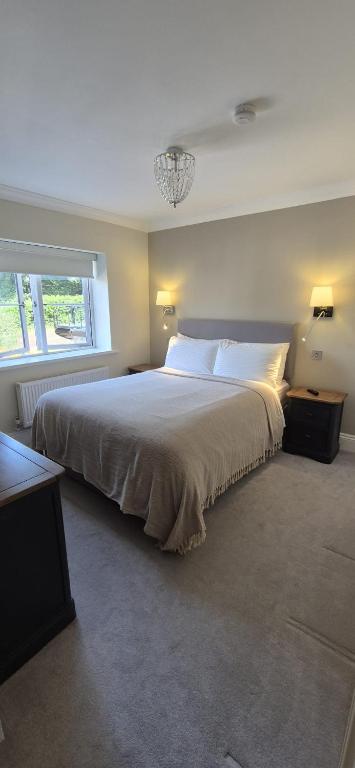 a bedroom with a large bed and a window at Marie House in Bowness-on-Windermere