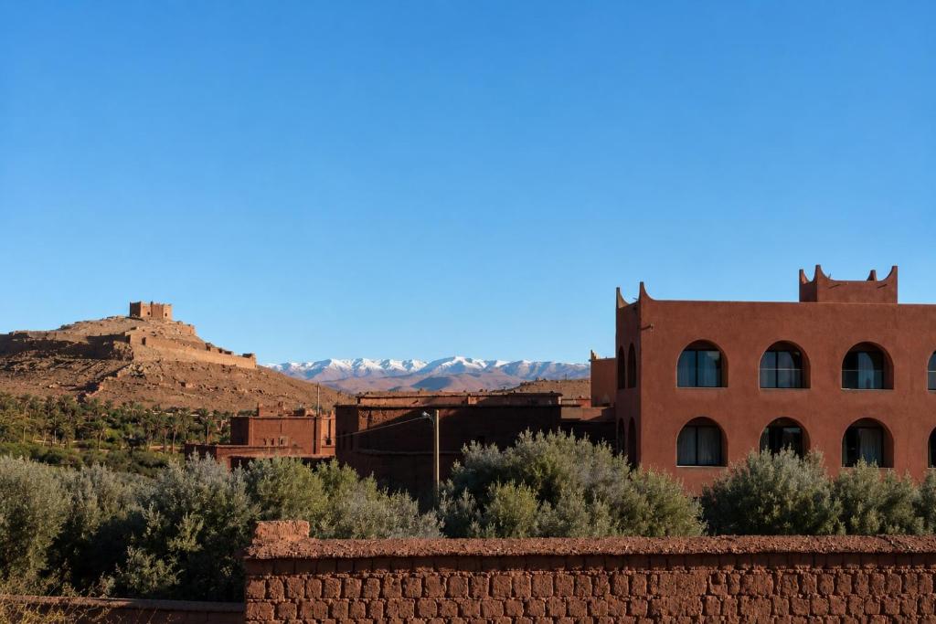 an old building in the desert with mountains in the background at TIZI Aït Ben Haddou in Aït Benhaddou