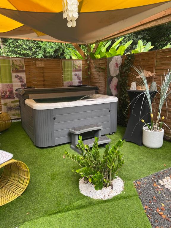 a large bed in a yard with grass and plants at Mon petit coin de paradis in Morne-à-lʼEau