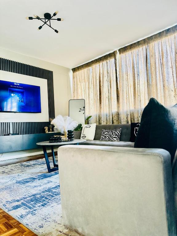 a living room with a couch and a table at Home By The Sea in Gqeberha