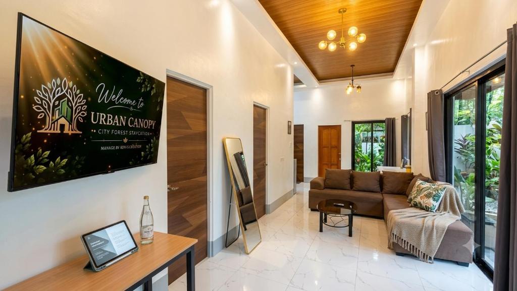 a living room with a couch and a table at Urban Canopy City Forest Staycation in Tigbawan