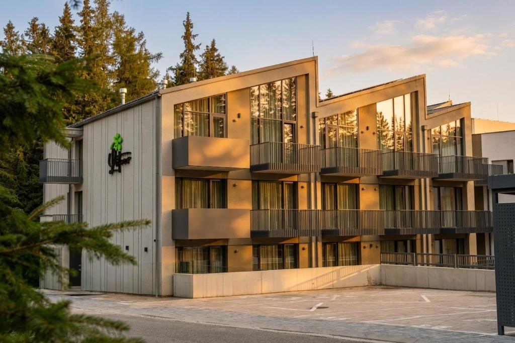 an exterior view of a building with balconies at APLEND Aparthotel Litvor in Štrba