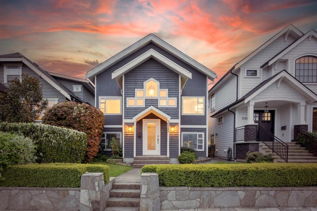 a house with a sunset in the background at Family-Friendly 3BR Home in Vancouver