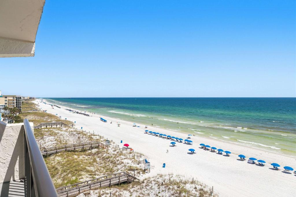 a view of a beach with umbrellas and the ocean at Seventh-floor oceanfront condo with pool access ocean view & central AC in Fort Walton Beach