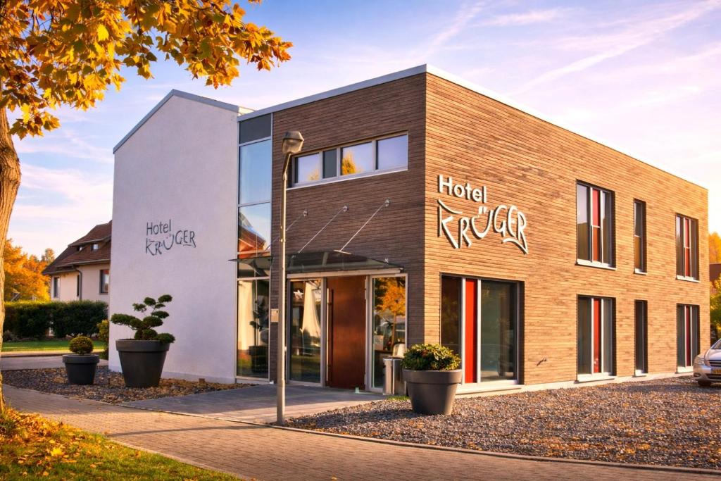 a building with a sign that reads hotel uber at Hotel-Restaurant Krüger in Grafhorst
